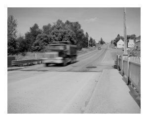 A dump truck above to cross the Fort Street Bridge in Caribou, Maine.