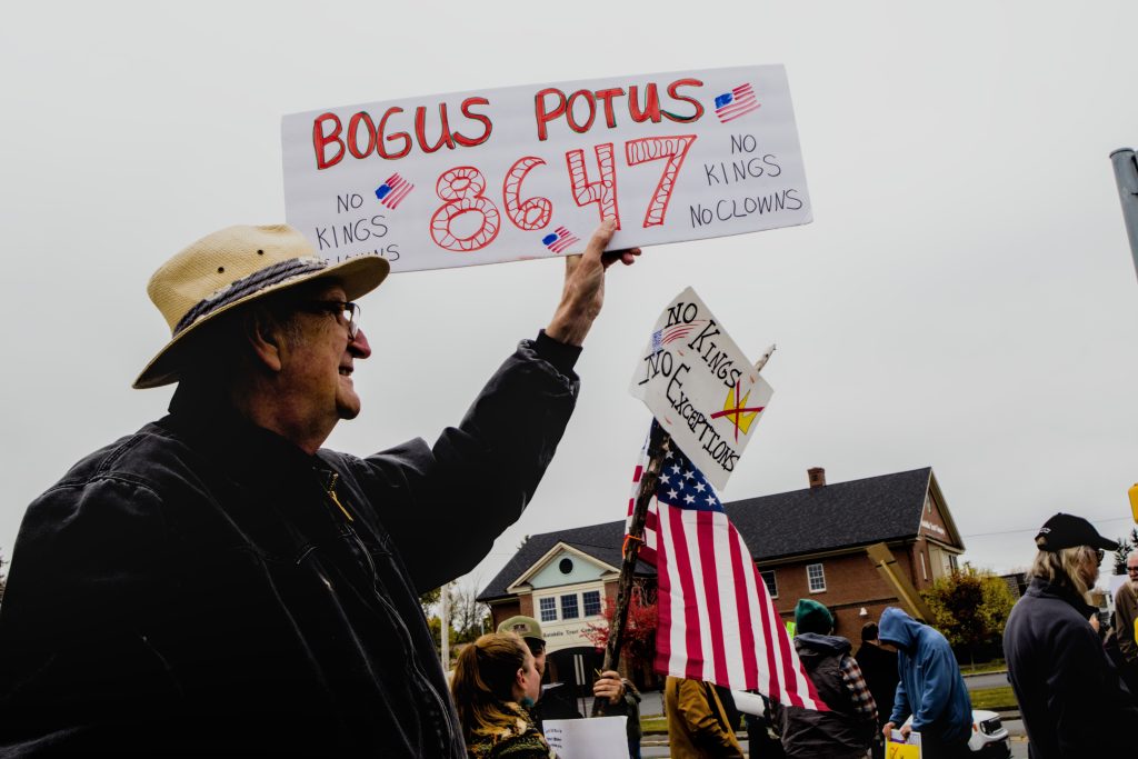 A protester displays a sign that reads "BOGUS POTUS, 8647" during the No Kings protest in Presque Isle, Maine, on October 18th, 2025.
