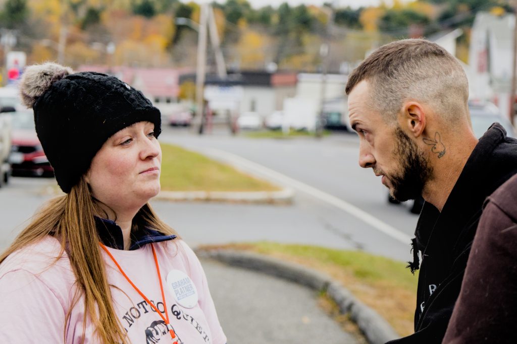 AOC organizer Melanie Tompkins listens to a local man explain why he feels the No Kings protest is trampling his right to free speech.