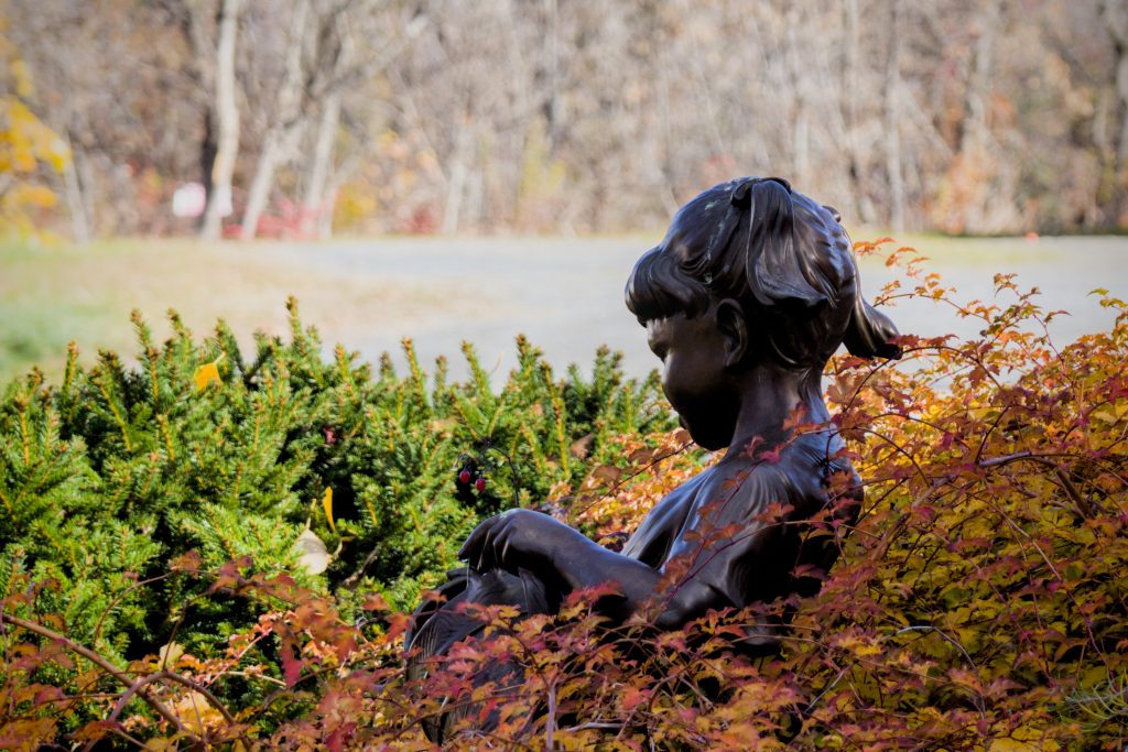 A statue of a young girl holding a watering can in a small park just off Main Street in Caribou, Maine.