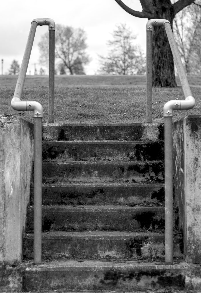Concrete stairs with metal pipes as handrails.