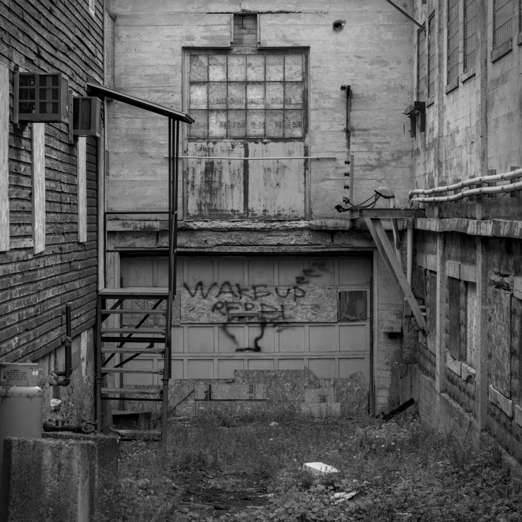 Some graffiti on a disused garage.